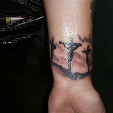 crucifixion tattoos|3 crosses forearm tattoo.